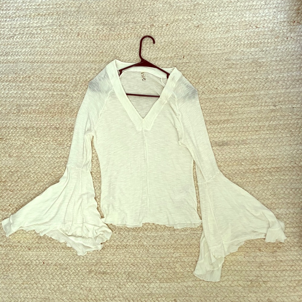 Free People blouse with bell bottom sleeves.